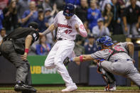 <p>Milwaukee Brewers’ Jett Bandy just beats the tag of New York Mets’ Kevin Plawecki to score during the fifth inning of a baseball game, May 13, 2017, in Milwaukee. (Photo: Tom Lynn/AP) </p>