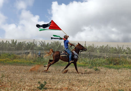 A man rides a horse during a rally of Israeli Arabs calling for the right of return for refugees who fled their homes during the 1948 Arab-Israeli War, near Atlit, Israel April 19, 2018. REUTERS/Ammar Awad