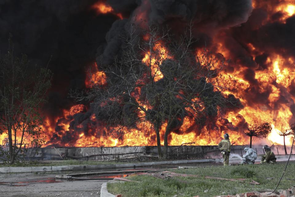 Donetsk People Republic Emergency Situations Ministry firefighters work at the site of fire at the oil depot after missiles struck the facility in an area controlled by Russian-backed separatist forces in Makiivka, 15 km (94 miles) east of Donetsk, eastern Ukraine, Wednesday, May 4, 2022. The representative office of the Donetsk People's Republic in the Joint Center for Control and Coordination of the ceasefire regime (JCCC) said on Wednesday that the city of Makiivka was shelled and, according to preliminary data, an oil depot was on fire. (AP Photo)