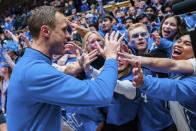 Duke head coach Jon Scheyer celebrates with fans after defeating North Carolina during an NCAA college basketball game on Saturday, Feb. 4, 2023, in Durham, N.C. (AP Photo/Jacob Kupferman)