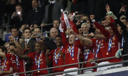 Britain Soccer Football - Southampton v Manchester United - EFL Cup Final - Wembley Stadium - 26/2/17 Manchester United's Wayne Rooney lifts the trophy to celebrate winning Action Images via Reuters / Carl Recine