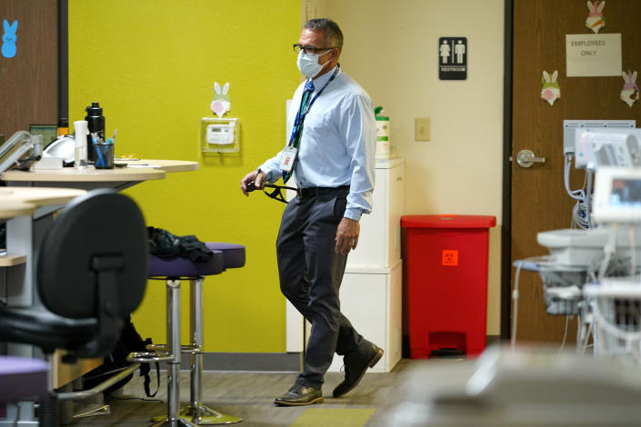 Nurse practitioner Anthony Carano makes his rounds at the Mountain Park Health Center, Thursday, March 30, 2023, in Phoenix. As heat waves fueled by climate change arrive earlier, grow more intense and last longer, people over 60 who are more vulnerable to high temperatures are increasingly at risk of dying from heat-related causes. Heat related deaths are challenging community health systems, utility companies, apartment managers and local governments to better protect older people when temperatures soar.(AP Photo/Matt York)