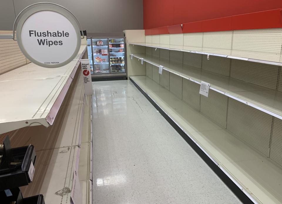 The same day President Donald Trump announced that he was declaring the coronavirus situation a national emergency, an aisle once stocked with flushable wipes and toilet paper sits emptied at a Target store Friday, March 13, 2020, at The Promenade at Brentwood in Brentwood, Mo. The store posted signs reading the store would be limiting quantities of disinfectant wipes, hand sanitizer, hand & face wipes, toilet paper and 24-pk of bottled water to four per guest. (Laurie Skrivan/St. Louis Post-Dispatch via AP)