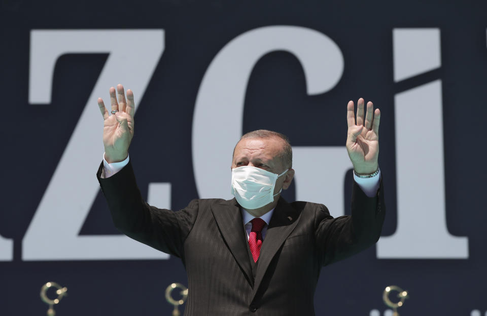 Turkey's President Recep Erdogan waves as he attends celebrations marking the anniversary of the 1071 battle of Manzikert, during which Turkish Seljuks beat Byzantine forces, gaining entry into Anatolia, in Malazgirt, eastern Turkey, Wednesday, Aug. 26, 2020. Erdogan warned Greece on Wednesday not to test his country's patience or courage, further stoking tensions between the NATO allies over offshore energy exploration in the eastern Mediterranean.(Turkish Presidency via AP, Pool)
