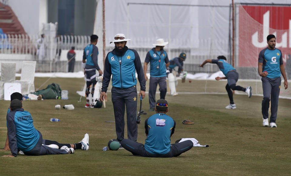 Head coach of the Pakistan cricket team Misbah-ul-Haq, center, talks with players during a practice session for the first test match against Sri Lanka at the Pindi stadium in Rawalpindi, Pakistan, Monday, Dec. 9, 2019. (AP Photo/Anjum Naveed)