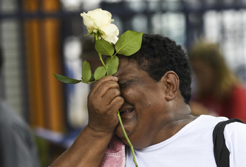 A relative of a victim cries during a tribute to those who died in the dam disaster last year in Brumadinho city, Minas Gerais state, Brazil, Saturday, Jan.25, 2020. The wave of mud and debris that on Jan. 25, 2019 buried the equivalent of 300 soccer pitches and killed 270 people, continues to barrel over residents' minds, the local economy and the environment, one year later. (AP Photo/Gustavo Andrade)