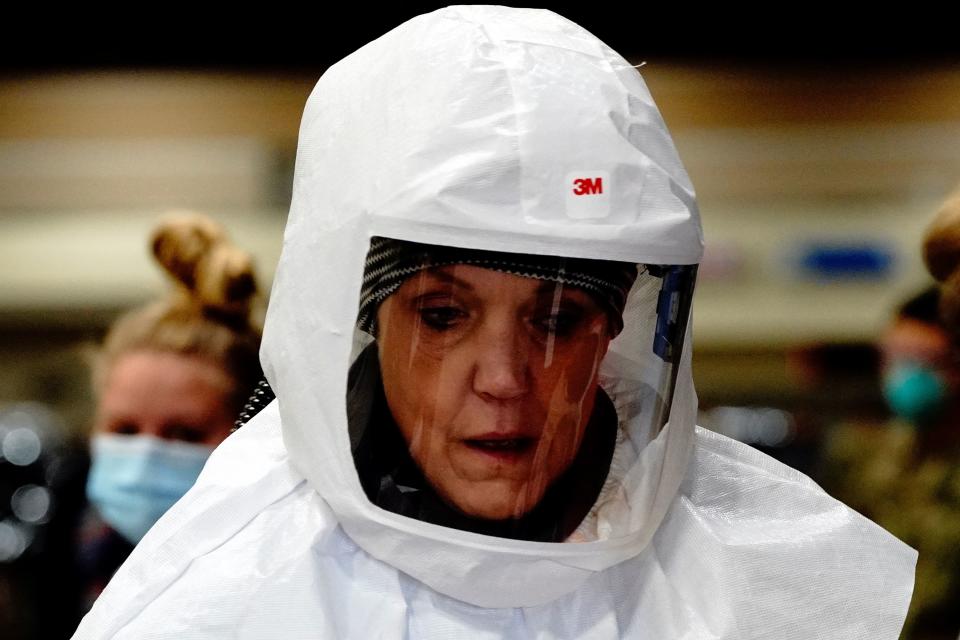 Registered nurse Deb Grabo, wearing a 3M powered air purifying respirator (PAPR) hood, prepares to begin her shift at a drive-thru testing site inside the Bismarck Event Center as the coronavirus disease (COVID-19) outbreak continues in Bismarck, North Dakota, U.S., October 26, 2020. REUTERS/Bing Guan