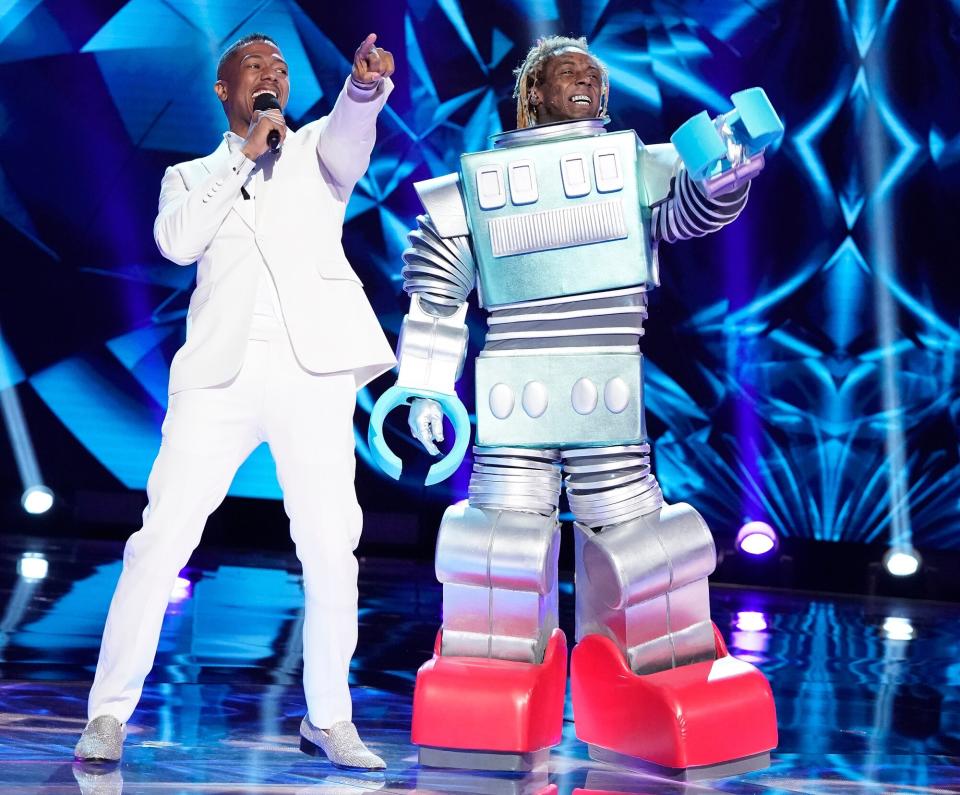 Host Nick Cannon and Lil Wayne in the Season Three premiere of THE MASKED SINGER