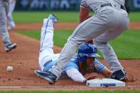 Jun 17, 2018; Kansas City, MO, USA; Kansas City Royals left fielder Alex Gordon (4) slides into third base ahead of the tag by Houston Astros third baseman Alex Bregman (2) in the first inning at Kauffman Stadium. Mandatory Credit: Jay Biggerstaff-USA TODAY Sports