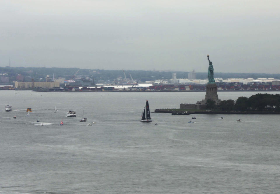 The Malizia II passes the Statue of Liberty with Swedish climate activist Greta Thunberg aboard, is escorted by a flotilla into New York Harbor at the conclusion of Thunberg's trans-Atlantic voyage, Wednesday, Aug. 28, 2019. The 16-year old Thunberg crossed the Atlantic aboard a zero-emissions sailboat to address the United Nations Climate Action Summit on Sept. 23. (AP Photo/Wong Maye-E)