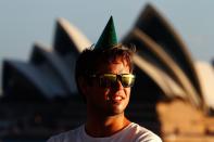 SYDNEY, AUSTRALIA - DECEMBER 31: A man wearing a party hat waits in anticipation of New Years Eve celebrations on Sydney Harbour on December 31, 2012 in Sydney, Australia. (Photo by Brendon Thorne/Getty Images)