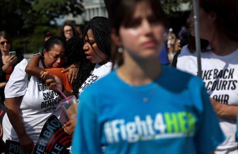 People rally outside of the U.S. Supreme Court as they wait for rulings in Washington, U.S.