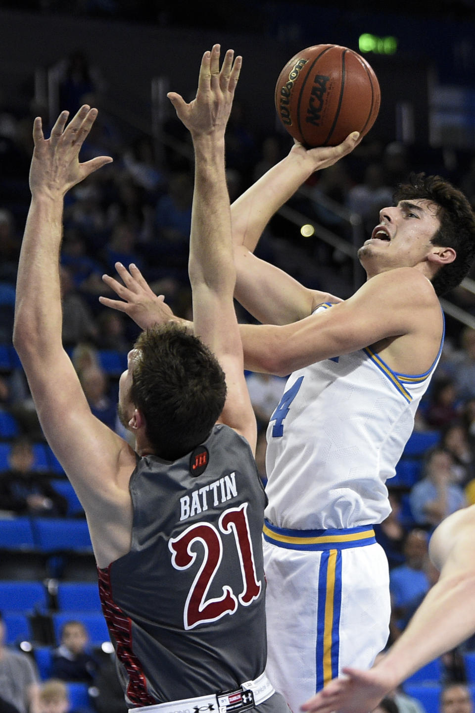 UCLA guard Jaime Jaquez Jr., right, shoots while Utah forward Riley Battin defends during the first half of an NCAA college basketball game in Los Angeles, Sunday, Feb. 2, 2020. (AP Photo/Kelvin Kuo)