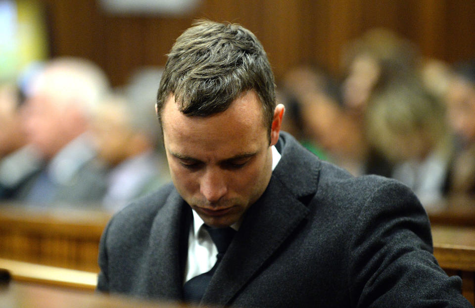 Oscar Pistorius sits in the dock as he listens to cross questioning, in the second week of his trial, about the events surrounding the shooting death of his girlfriend Reeva Steenkamp, in court during his trial in Pretoria, South Africa, Monday, March 10, 2014. Pistorius is charged with the shooting death of his girlfriend Steenkamp, on Valentines Day in 2013. (AP Photo/Bongiwe Mchunu, Pool)