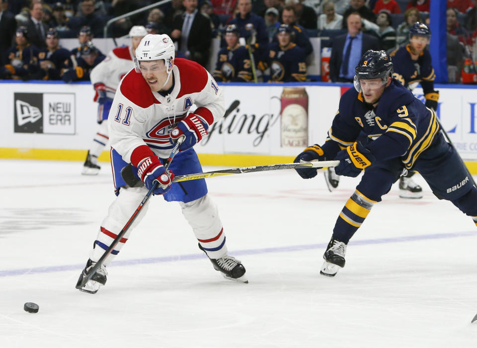 Buffalo Sabres forward Jack Eichel (9) stick-checks Montreal Canadiens forward Brendan Gallagher (11) during the second period of an hockey game, Friday, Nov. 23, 2018, in Buffalo N.Y. (AP Photo/Jeffrey T. Barnes)