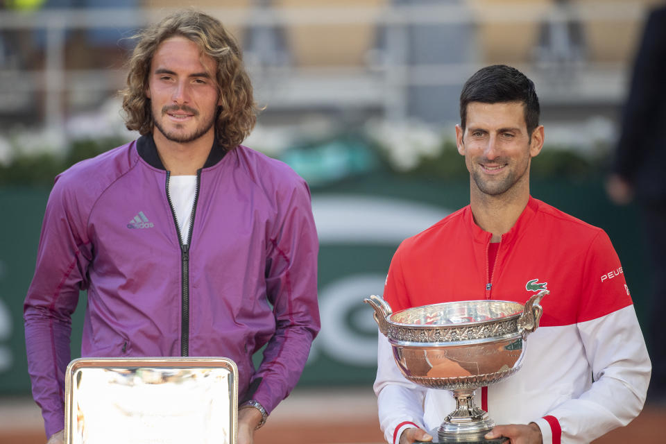 From right to left, winner Novak Djokovic and runner-up Stefanos Tsitsipas holding their silverware after the 2021 French Open final.