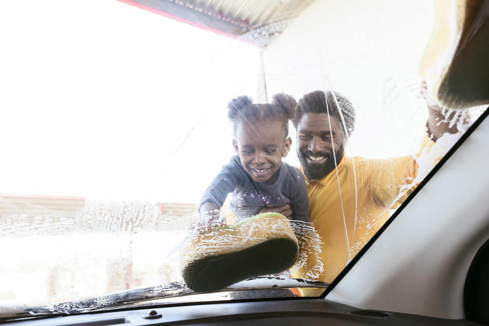 Father and daughter washing their car (KOLOstock / Getty Images)