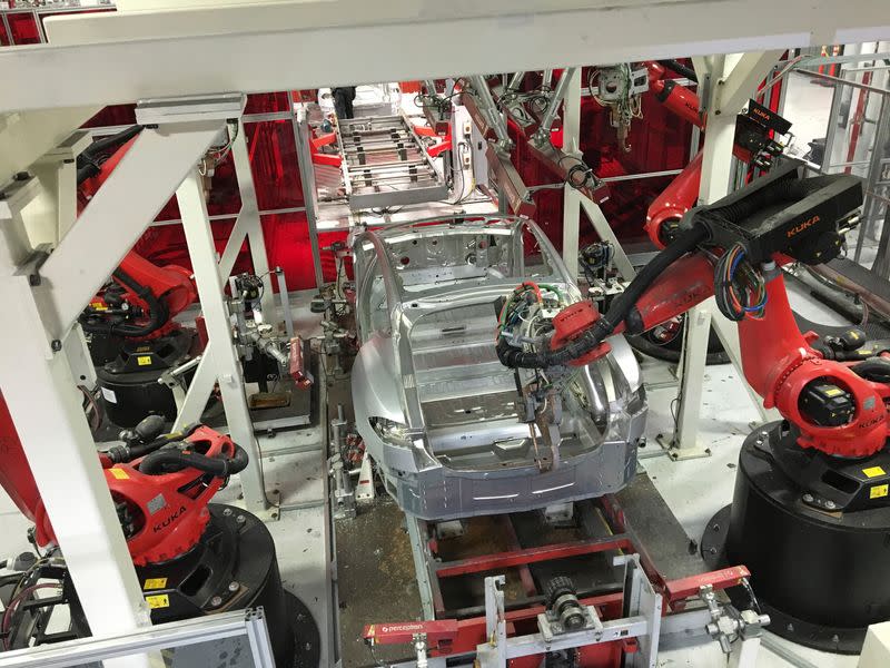 FILE PHOTO: Tesla vehicles are being assembled by robots at Tesla Motors Inc factory in Fremont