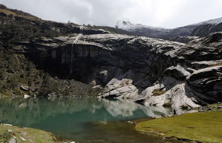 A boy fishes for trout at lake Rajupaquinan at Huascaran natural reserve in Ancash November 29, 2014. REUTERS/ Mariana Bazo