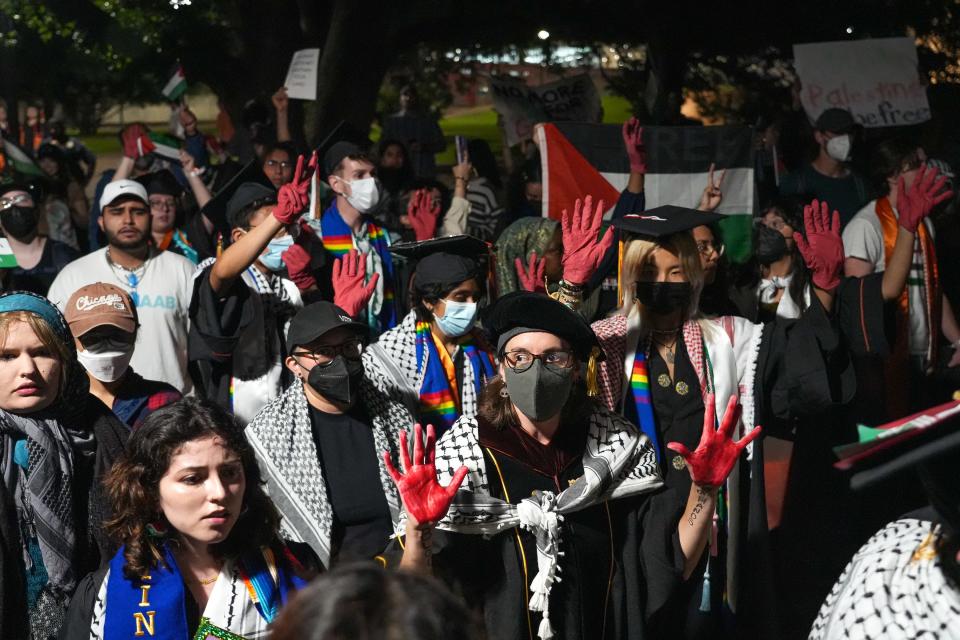 Pro-Palestinian protesters hold a rally outside Royal-Memorial Stadium after Saturday night's University of Texas commencement ceremony. They wore red gloves or painted their hands red to symbolize "the blood that UT has spilled."