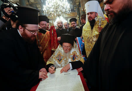 Ecumenical Patriarch Bartholomew and Metropolitan Epifaniy, head of the Orthodox Church of Ukraine, attend a signing ceremony marking the new Ukrainian Orthodox church's independence, at St. George's Cathedral, the seat of the Ecumenical Patriarchate, in Istanbul, Turkey January 5, 2019. REUTERS/Murad Sezer