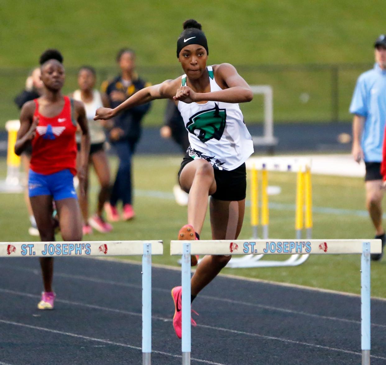 Washington sophomore Adrianna Swanson gets ready to leap over a hurdle during the 300-meter hurdles race at the girls track and field sectional Tuesday, May 14, 2024, at Saint Joseph High School in South Bend.