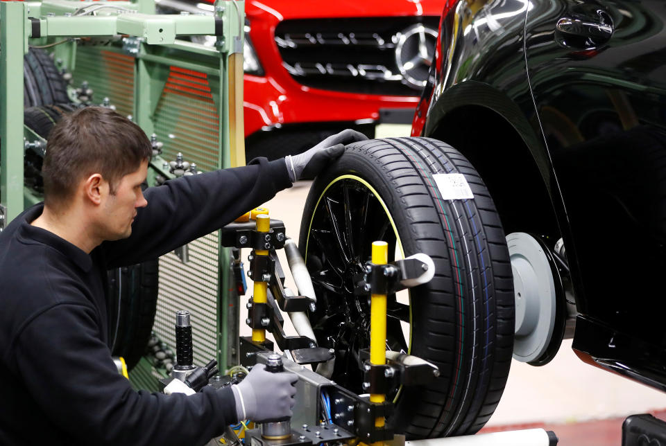 An employee of German car manufacturer Mercedes Benz installs wheels at a A-class model at the production line at the Daimler factory in Rastatt, Germany, February 4, 2019.  REUTERS/Kai Pfaffenbach