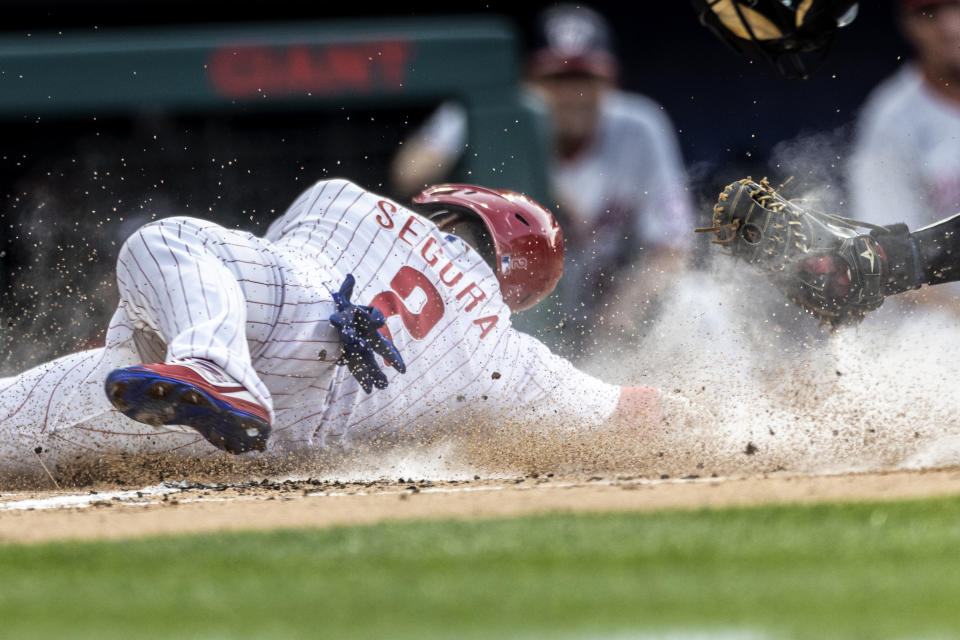 Philadelphia Phillies' Jean Segura (2) is out at home after Washington Nationals catcher Tres Barrera made a tag during the first inning of a baseball game, Monday, July 26, 2021, in Philadelphia. (AP Photo/Laurence Kesterson)