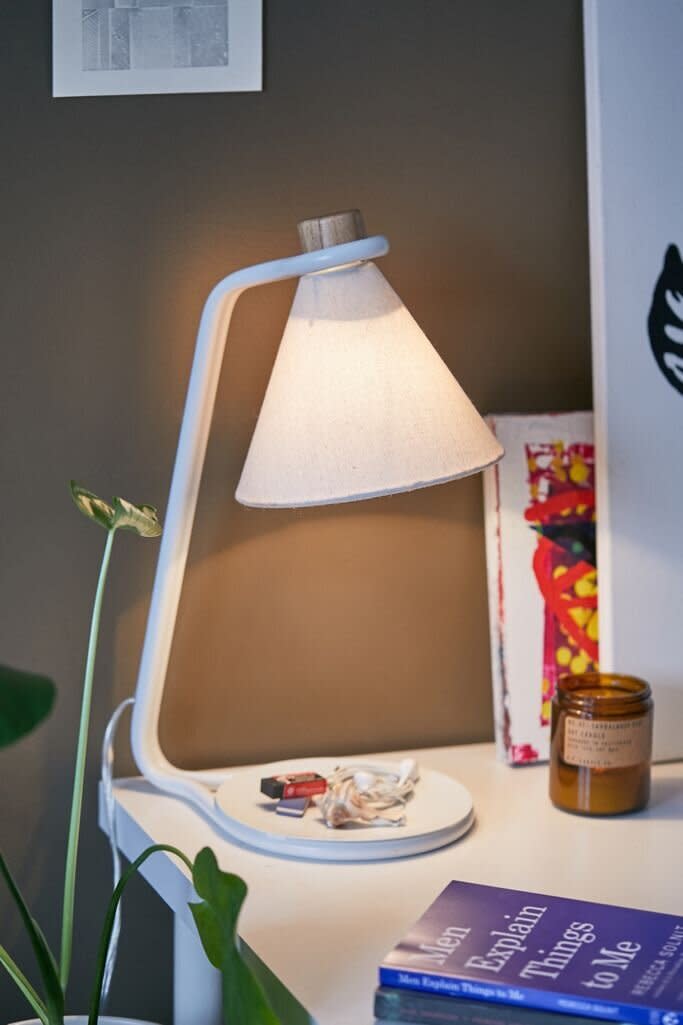 With a catch-all dish base, you can finally organize all the paper clips, bobby pins and thumb tacks you keep on your desk with this lamp. It's retro-inspired, so it'll go with your <a href="https://www.huffpost.com/entry/best-sites-for-midcentury-modern-furniture_n_596fcbdce4b062ea5f8ef4f3" target="_blank" rel="noopener noreferrer">mid-century modern aesthetic</a>. You can plug in this lamp, which requires a <a href="https://fave.co/3iyjiJL" target="_blank" rel="noopener noreferrer">60-watt bulb</a>. But the shade is already included. <a href="https://fave.co/33BXG9s" target="_blank" rel="noopener noreferrer">Find it for $59 at Urban Outfitters</a>.