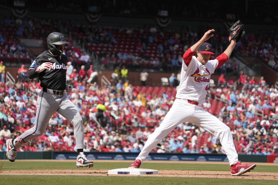 Miami Marlins' Jazz Chisholm Jr., left, grounds out as St. Louis Cardinals starting pitcher Kyle Gibson covers first during the fifth inning of a baseball game Sunday, April 7, 2024, in St. Louis. (AP Photo/Jeff Roberson)