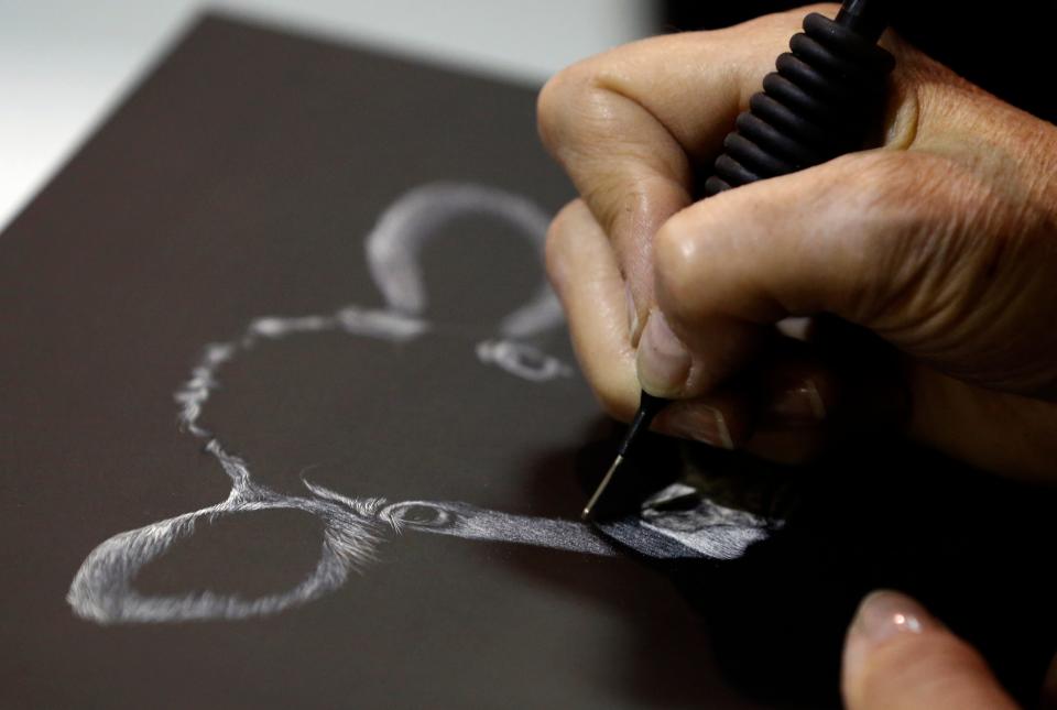 Oklahoma artist Linda Kukuk, who is Choctaw and Cherokee, works on her art during the 2014 Red Earth Festival at Remington Park on Friday, June 6, 2014, at Remington Park in Oklahoma City, Okla.