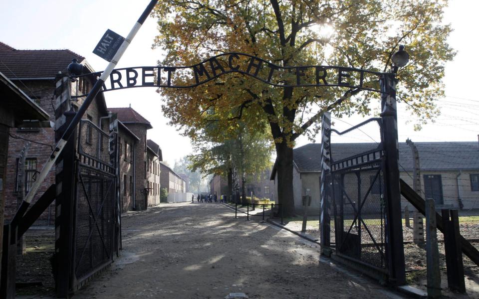 The entrance to Auschwitz with the inscription "Arbeit Macht Frei" (Work Sets You Free) - Czarek Sokolowski/AP