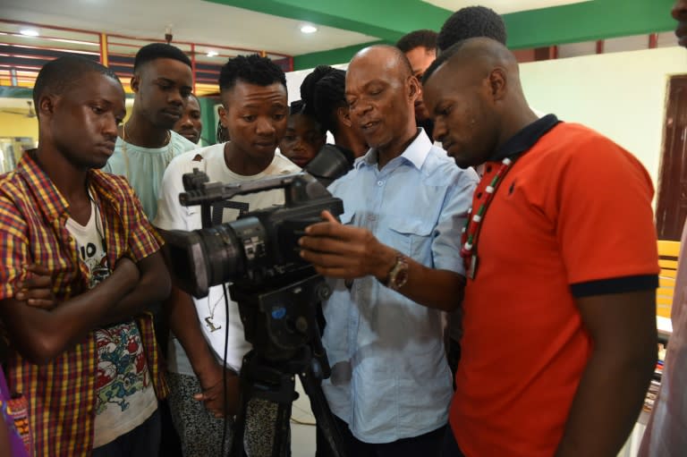 A teacher (C) at the PEFTI Film Institute teaches students to use a video camera, in Lagos