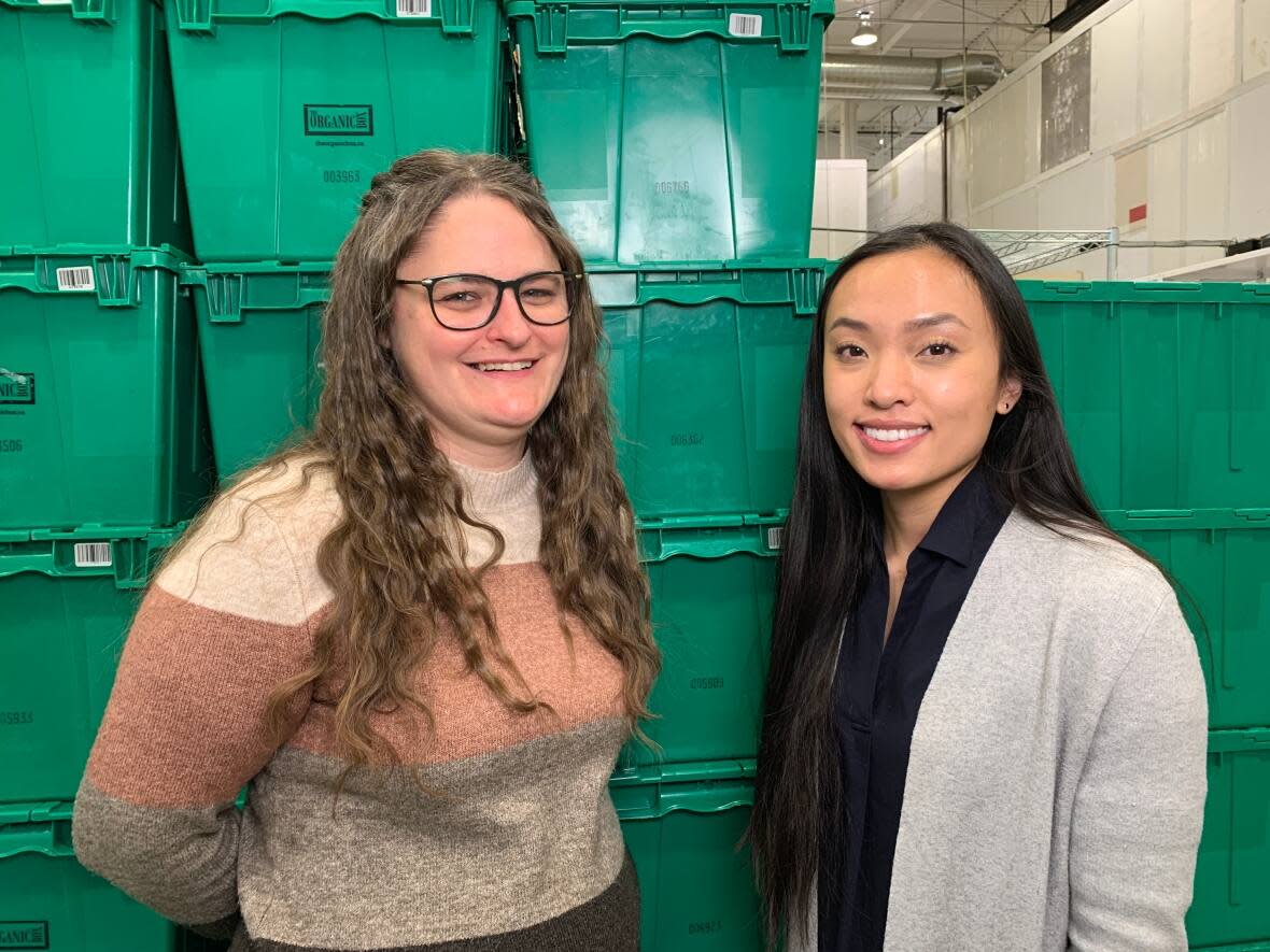 Heidi Ellis, purchasing manager with The Organic Box, and Julia Tran, food dignity program manager with the Multicultural Health Brokers Co-operative, are collaborating on Khair for All, a new affordable food box service in Edmonton. (Madeleine Cummings/CBC - image credit)