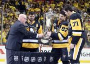 May 25, 2017; Pittsburgh, PA, USA; NHL deputy commissioner Bill Daly (left) presents the Prince of Wales trophy to Pittsburgh Penguins left wing Chris Kunitz (14) and center Sidney Crosby (87) and center Evgeni Malkin (71) as champions of the Eastern Conference after the Pens defeated the Ottawa Senators in double overtime of game seven of the Eastern Conference Final of the 2017 Stanley Cup Playoffs at the PPG PAINTS Arena. Mandatory Credit: Charles LeClaire-USA TODAY Sports