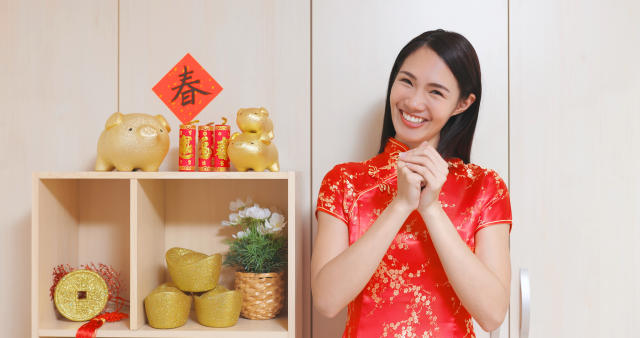 Asian girl greets happy Chinese New yYear with folded hands. PHOTO: Getty Images