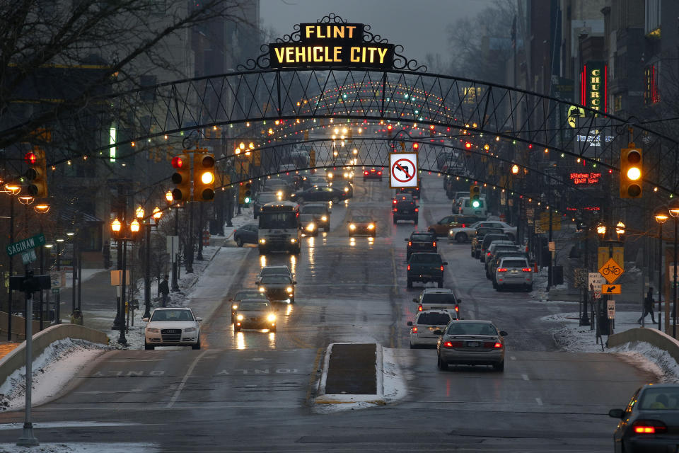 FILE - In this Jan. 21, 2016. file photo vehicles drive through downtown Flint, Mich. Picketing auto workers have surrounded the massive General Motors complex for nearly a week in Flint, the automaker's birthplace. Picketing auto workers have surrounded the massive General Motors complex for nearly a week of Friday, Sept. 20, in Flint, the automaker’s birthplace. The city and many workers have been here before: A 54-day strike at a Flint plant in 1998 forced a companywide shutdown. (AP Photo/Paul Sancya, File)