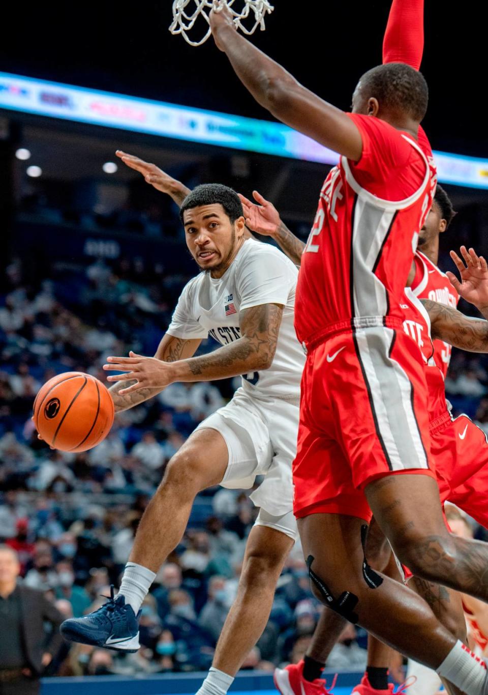 Penn State’s Sam Sessoms tries to pass to a teammate after getting blocked at the net by Ohio State defedners during the game on Sunday, Dec. 5, 2021.