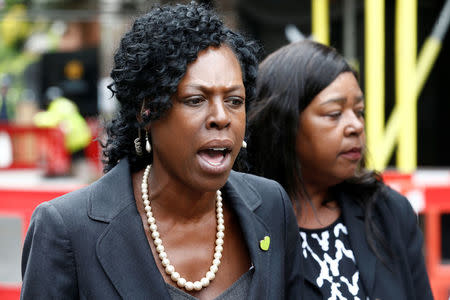 Yvette Williams, representing Justice 4 Grenfell, and Clarrie Mendy-Solomon, who lost two family members in the disaster, speak outside a commemoration hearing at the opening of the inquiry into the Grenfell Tower disaster, in London, Britain May 21, 2018. REUTERS/Henry Nicholls