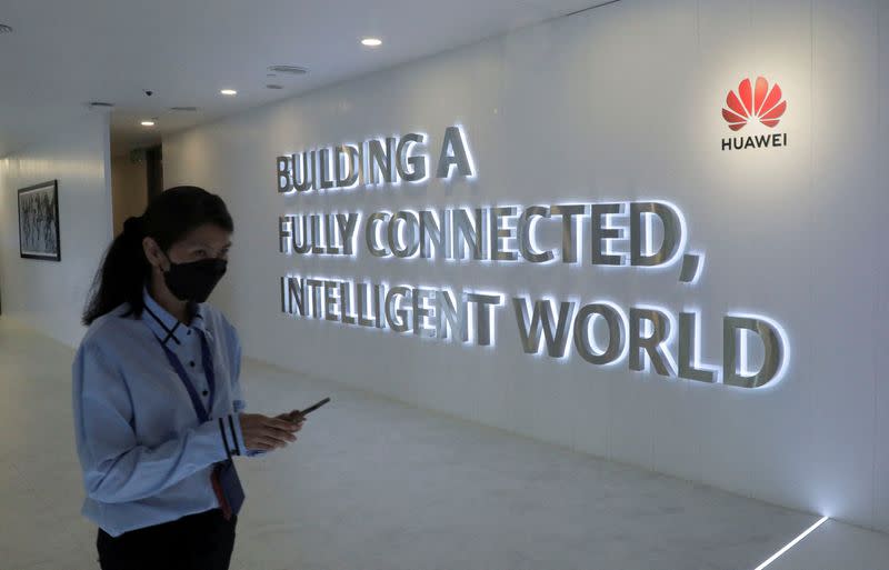 FILE PHOTO: A Huawei's staff uses her smartphone at the telecommunication company's Customer Experience Centre in Kuala Lumpur