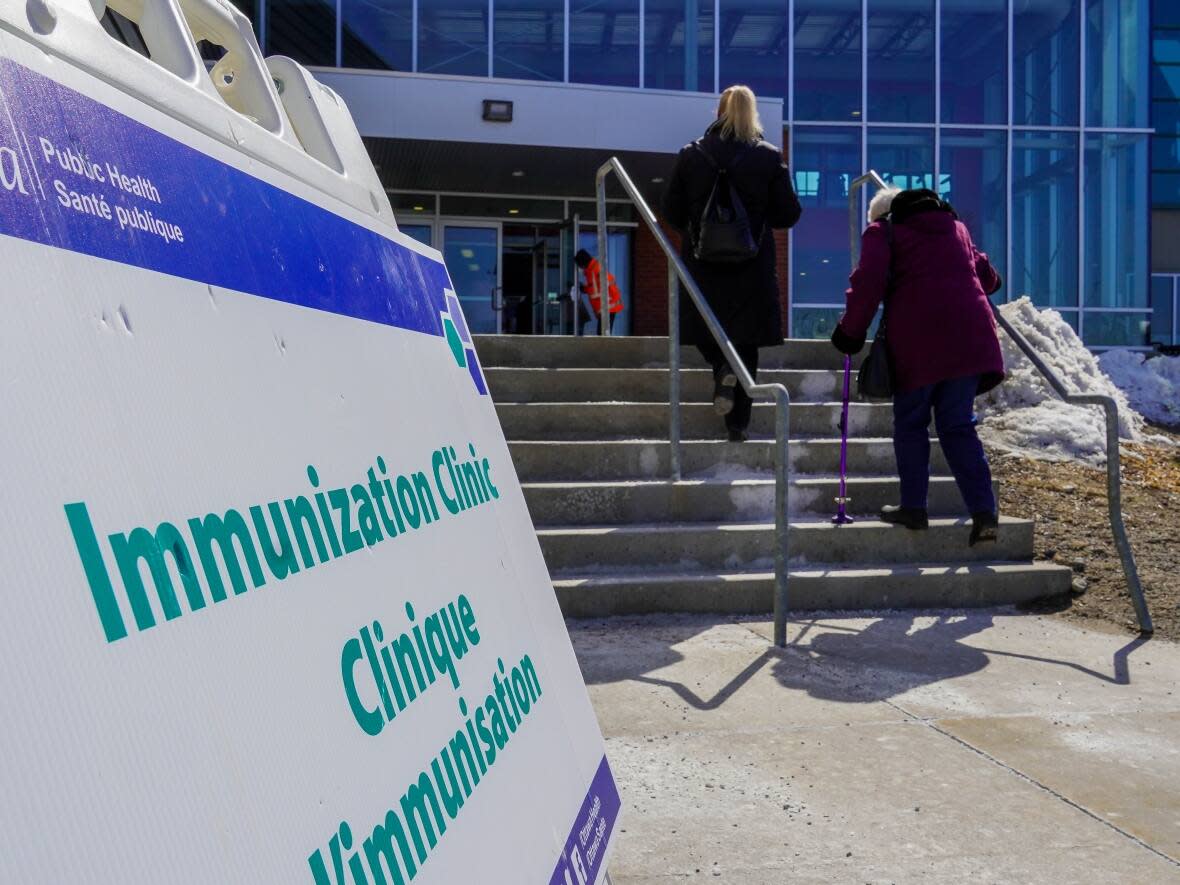 People enter a COVID-19 vaccine clinic at the Ruddy Family YMCA-YWCA in early 2021. The building has been sold and the recreation facility will close, although the city-run clinic will continue to operate. (Jean-Delisle/CBC - image credit)