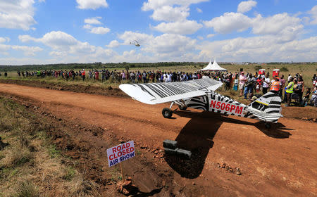 A plane prepares to take-off from a dirt road used as a makeshift runway during the Vintage Air Rally at the Nairobi national park in Kenya's capital Nairobi, November 27, 2016. REUTERS/Thomas Mukoya