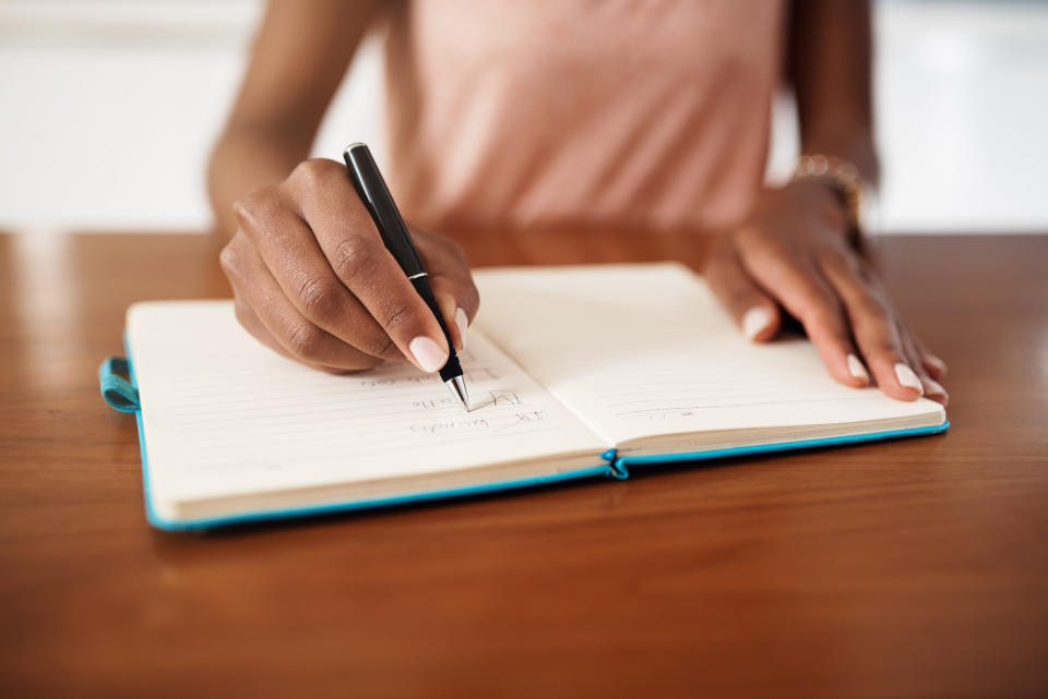 A woman writes in a journal