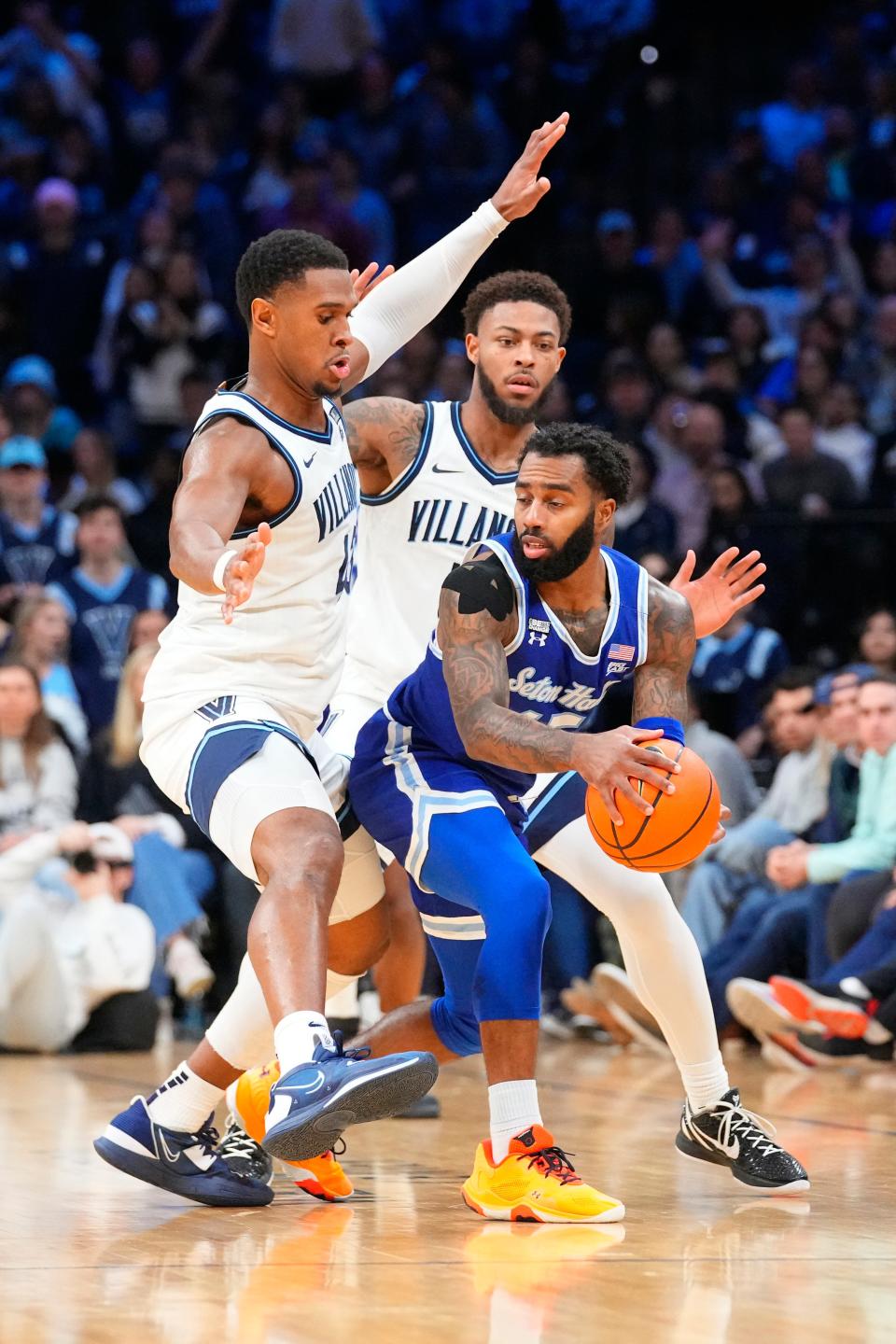 Villanova Wildcats forward Eric Dixon (43) and guard Justin Moore (5) double team Seton Hall Pirates guard Jamir Harris (15)