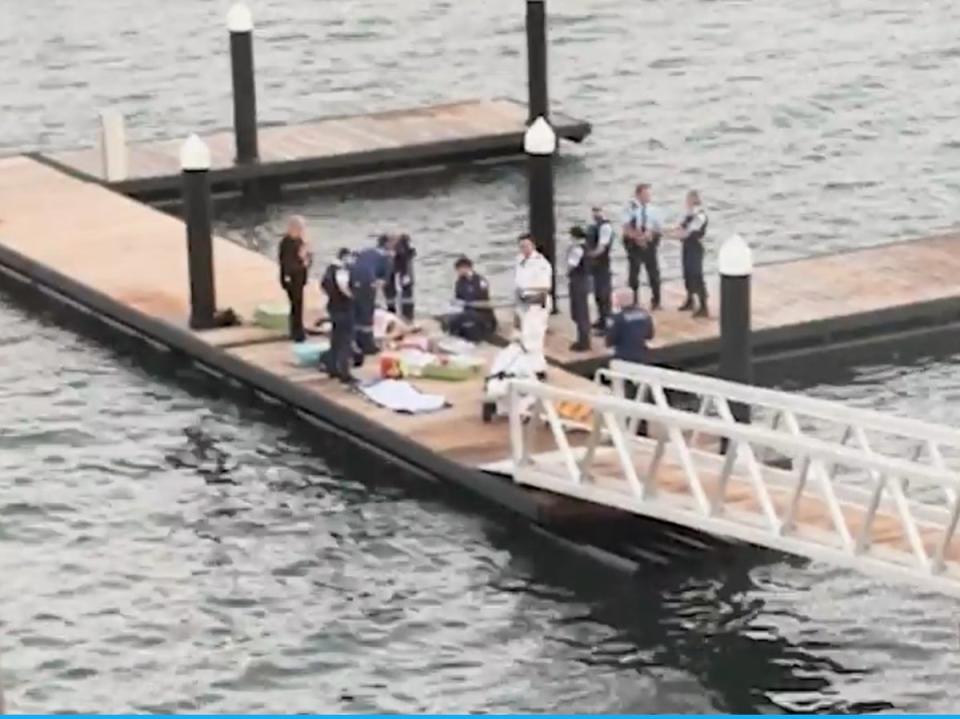 Paramedics attend to woman after shark attack (Screengrab/ NCA NewsWire)