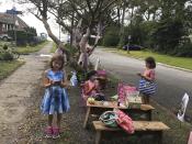 Maya Gebler, center, Cate and Sophie Carroll , right, write letters to fairies in Norfolk, Virginia on Monday Oct. 12, 2020. In the last few months, more than 700 letters have arrived at a fairy tree village outside the home of a journalist and children's book author. (AP Photo/Ben Finley).