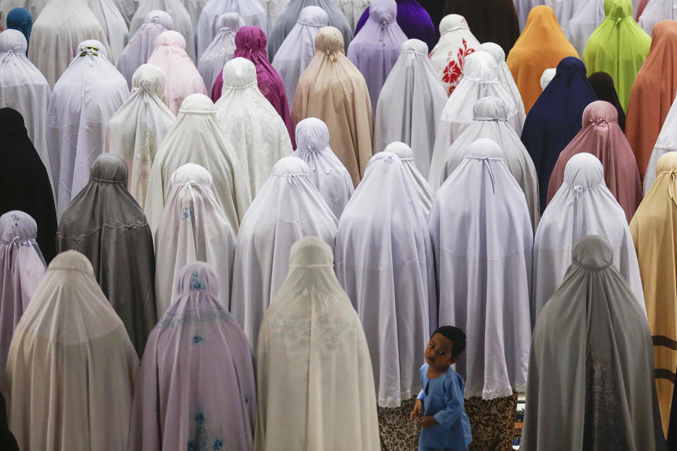 <p>A child plays while Muslim women perform an evening prayer called Tarawih, the night before the start of the holy fasting month of Ramadan at Tuanku Mizan Zainal Abidin Mosque in Putrajaya, Malaysia, May 26, 2017. Muslims around the world celebrate the holy month of Ramadan by praying during the nighttime and abstaining from eating, drinking, and sexual acts daily between sunrise and sunset. Ramadan is the ninth month in the Islamic calendar, and it is believed that the Koran’s first verse was revealed during its last 10 nights. (Photo: Fazry Ismail/EPA) </p>