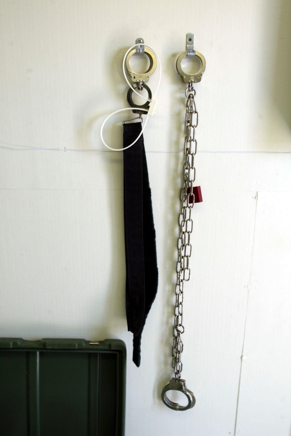 Restraining devices hang from the wall of a prisoner's cell at Camp Echo April 7, 2004 where detainees from the U.S. war in Afghanistan will meet their lawyers before going to a U.S. military tribunal in Guantanamo Bay, Cuba. On April 20, the U.S. Supreme Court is expected to consider whether the detainees can ask U.S. courts to review their cases. Approximately 600 prisoners from the U.S. war in Afghanistan remain in detention. (Photo by Joe Raedle/Getty Images)