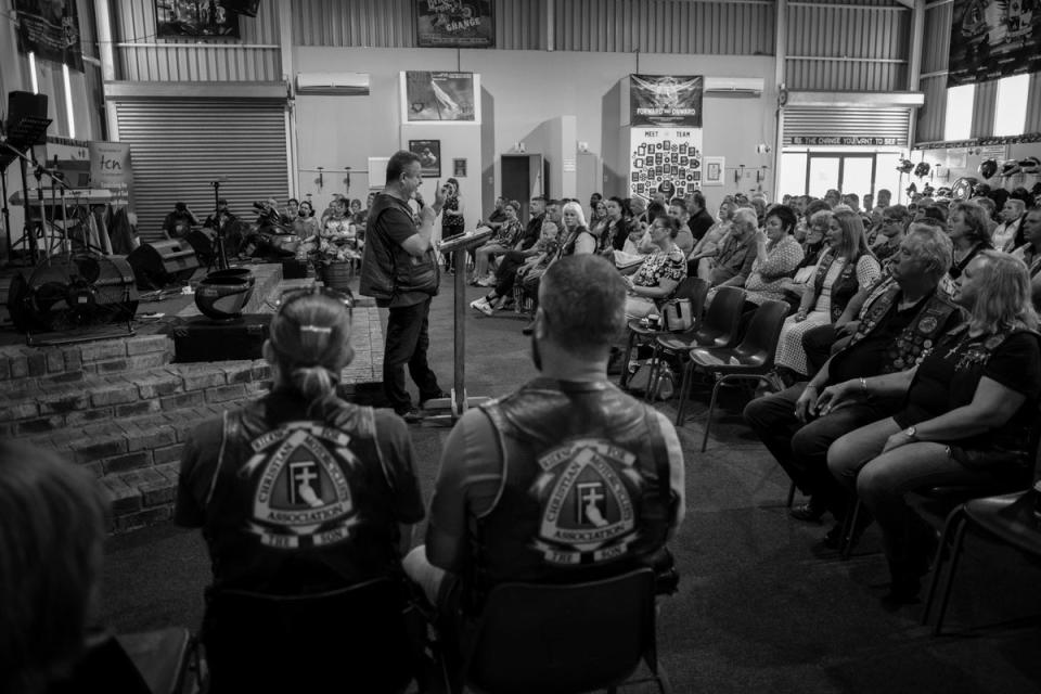 Members of the CMA Midvaal chapter listen to a sermon from a chapter member at their biker church in Vereeniging (EPA)