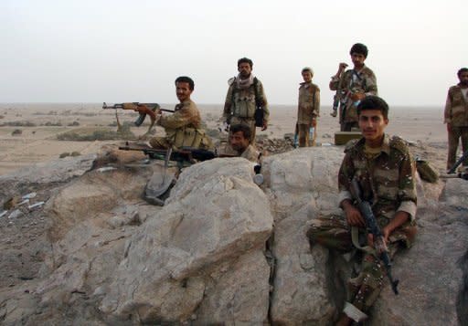 Yemeni soldiers pose with their weapons during an assault on the town of Jaar on May 30. Yemeni troops have made major advances into the southern city of Zinjibar, a major bastion of Al-Qaeda, shortly after it recaptured the nearby town of Jaar, a military official told AFP